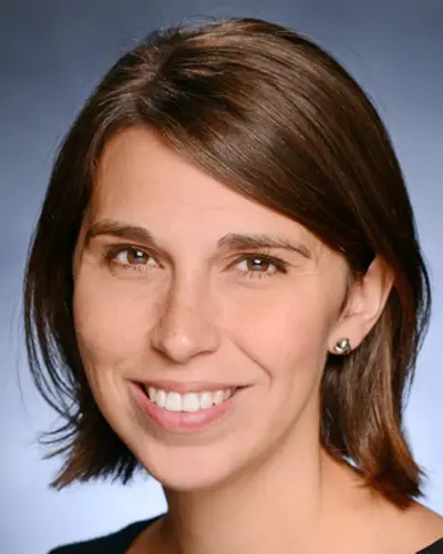 Headshot of Heather Danysh smiling against a blue background